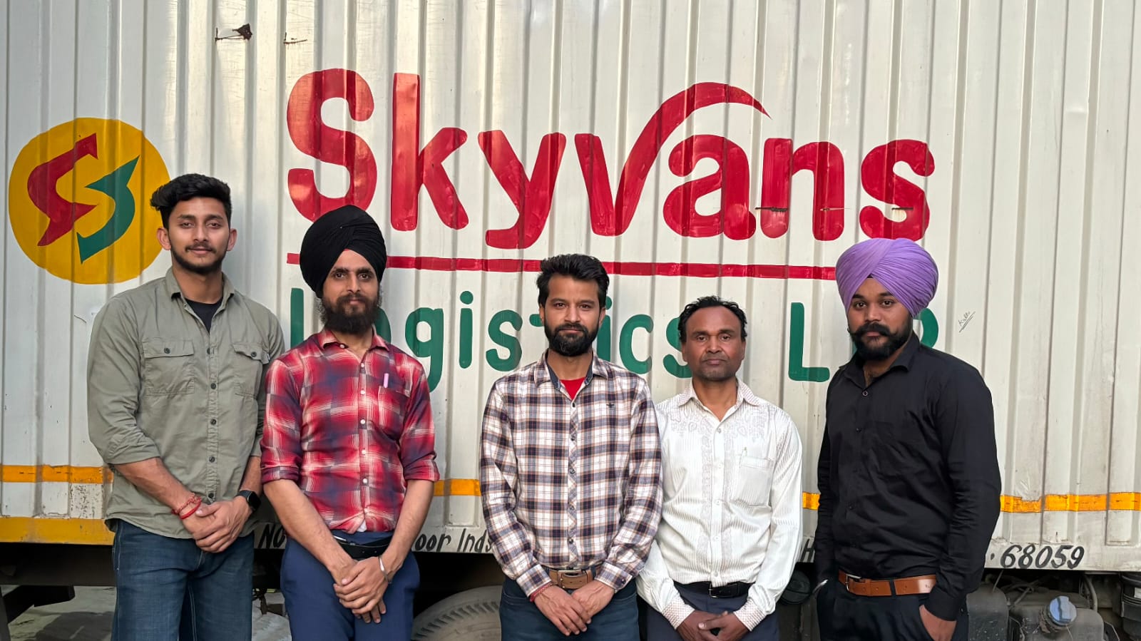 Skyvans Logistics team beside a company-branded freight vehicle